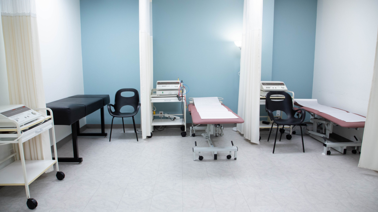 three physiotherapy treatment beds with electrode machines nearby